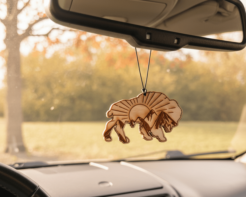 Car interior with a hanging air freshener featuring a bison design.