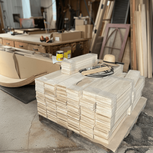 Stack of wooden boards on a pallet in an industrial setting